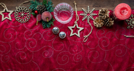 A red table runner with festive holiday decorations along the top.