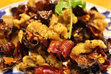 Sichuan cuisine (Chinese cuisine): fried chicken and chili peppers with coriander