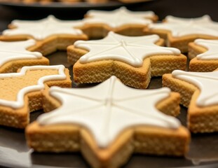 Star-Shaped Cookies with Icing Decor on a Dark Plate