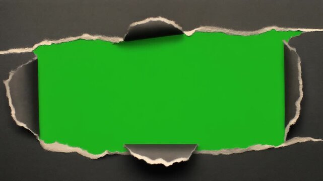 Ripped dark paper effect revealing a bright green screen placeholder for creative content