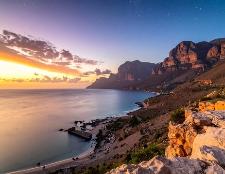 A coastal scene at sunset featuring mountains, a serene ocean, and rocky terrain with a pastel sky