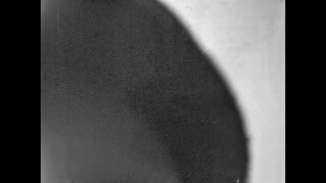 Shy boy poses alone before camera, eyes wide with quiet curiosity. Tentative smile and gentle posture, soft portrait of childhood. Old film. Archival retro 1960s. Vintage archive.