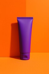 Vivid purple cosmetic tube leaning on a matte vertical orange panel, featuring bold color contrast, clean shadows, and modern minimal product styling.

