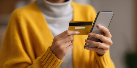 Woman uses smartphone and credit card for online shopping