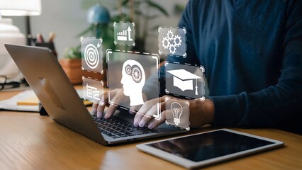 A person typing on a laptop with glowing digital overlays showing a graduation cap light bulb gears and a target icon in a productive workspace