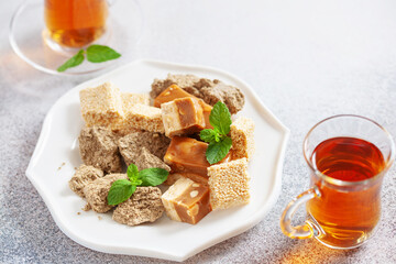 Oriental sweetness.  Nougat, halva and  tea on a table.