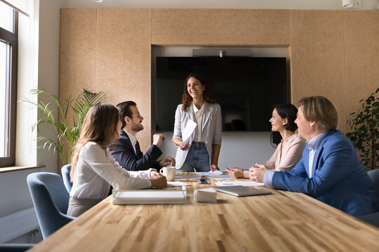 Smiling woman business trainer leading education workshop for company staff