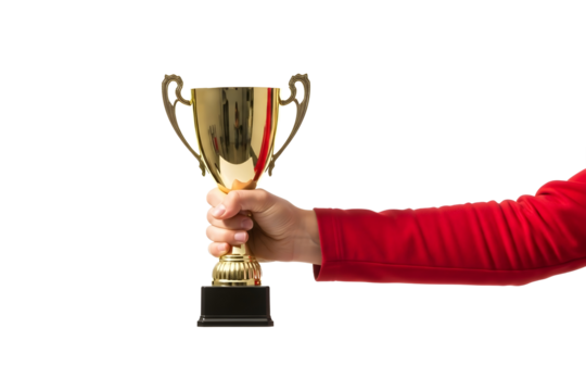 A person's hand in a red sleeve proudly holding a shiny gold trophy cup award for first place victory