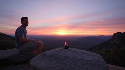 Majestic snow-capped mountains reflecting in a calm icy lake with a small cabin nestled amongst the peaks under a clear blue sky, a breathtaking winter panorama