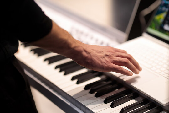 keyboard player records music on laptop