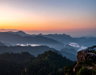 A serene mountain range at dawn or dusk, with layers of blue ridges, a vibrant sky, and trees