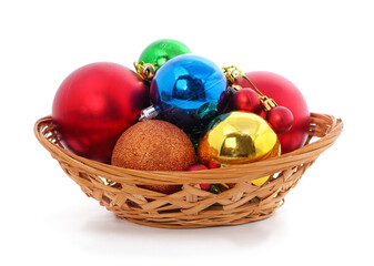 Basket of Christmas ornaments isolated on a white background.