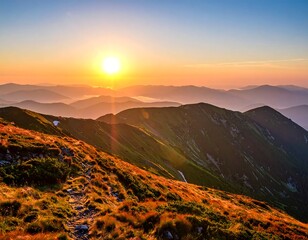 A vibrant sunset paints the mountain peaks. Hues of orange and yellow light up a distant path. Layers of mountains create a picturesque landscape