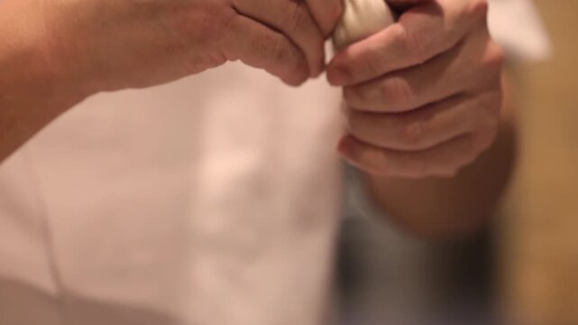 Hands preparing various Asian dumplings including jiaozi shumai har gow tang yuan and fried guo tie showing dough wrapping meat fillings in an authentic culinary process 