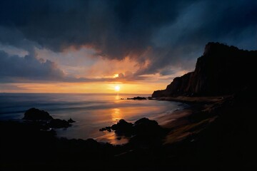 Dramatic sunset over ocean, golden light reflecting on waves, dark cliffs silhouetted against vibrant orange and blue sky.
