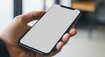 Hand Holding Smartphone with Blank Screen for Template or Mockup Use in Modern Environment