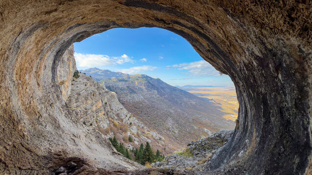 Watching the mystical mountain ranges from the large and wide cave - Powered by Adobe