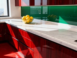 Modern Red and White Kitchen Interior with Marble Countertop and Sunlight