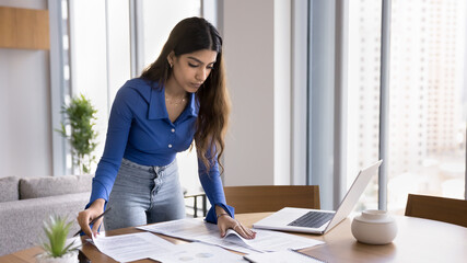 Serious busy Indian project manager woman working from home
