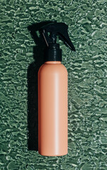 Pink hair spray bottle glass surface concept