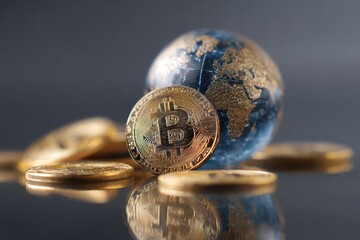 Bitcoin coins and a digital globe represent global cryptocurrency trends in a modern financial landscape