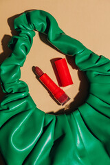 Green vintage bag and red lipstick top view