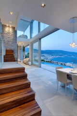 Fototapeta premium Luxury modern villa interior with sea panorama at dusk