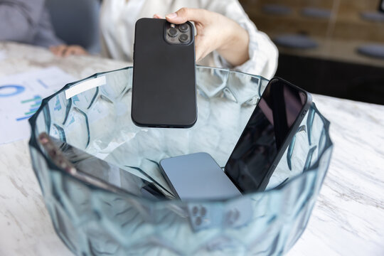 Female business professional refusing smartphone on meeting - Powered by Adobe