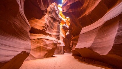 A narrow canyon showcases smooth, sculpted sandstone walls, bathed in sunlight from the opening above