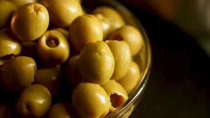 Fresh olives spilling from a bowl in a rustic kitchen setting