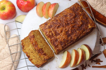 Apple cinnamon bread. Freshly baked loaf with slices cut, showing moist interior and golden crust