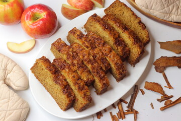 Apple cinnamon bread. Freshly baked loaf with slices cut, showing moist interior and golden crust