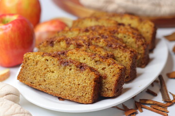 Apple cinnamon bread. Freshly baked loaf with slices cut, showing moist interior and golden crust