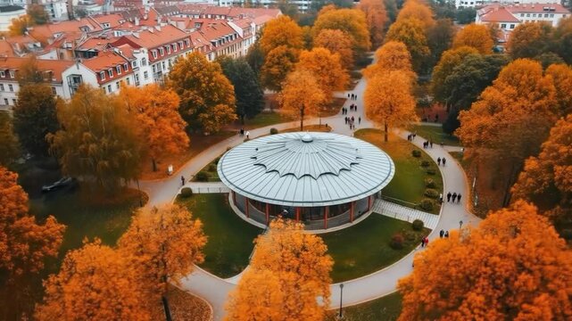 Aerial view of a park with autumn foliage and a bandstand in ljubljana
