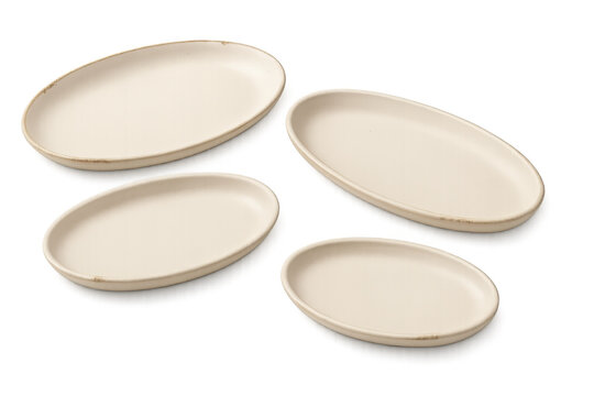 Beige ceramic oval plates set for food presentation, rustic tableware, empty kitchen dish collection