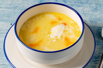 Creamy seafood soup with shrimp and spices served in white bowl