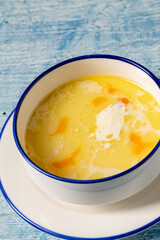 Creamy seafood soup with shrimp and spices served in white bowl