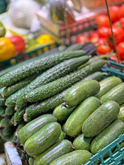 These green cucumbers are ready to be purchased and enjoyed as a healthy snack or ingredient in a meal