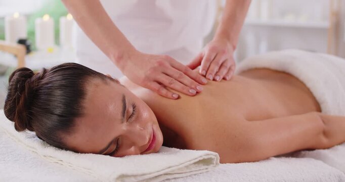 Relaxing female body massage pleasure, stimulating skin health, massage therapist doing spa shoulder, back care to relax muscles, energizing, give therapeutic beauty treatment and care