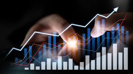 Close-up of hands interacting with digital financial graphs that show trends and growth, representing a modern approach to data analysis in business environments. Scalp