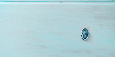 close-up of a small cabinet door handle