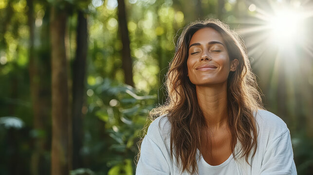 Serene woman breathing forest air, eyes closed, sunlight streaming, relaxed expression
