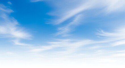 Fototapeta premium Beautiful blue sky with soft white clouds creating a peaceful and serene atmosphere in the bright sunny day