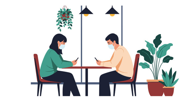 Two people sit at a table in a cafe wearing masks and looking at their phones.
