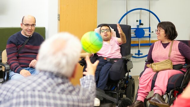 Group of adults with physical disabilities playing ball