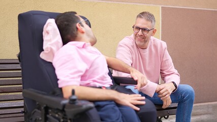 Obraz premium Friends communicating with man with physical disability in wheelchair