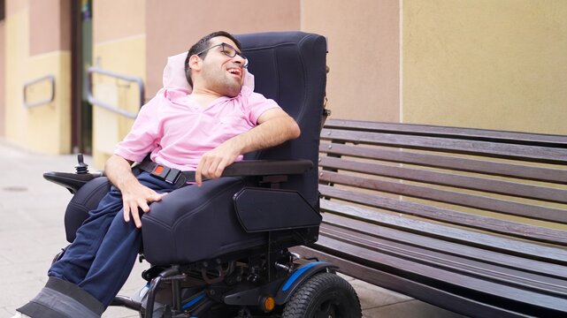 Man in power wheelchair enjoying inclusive outdoor urban space