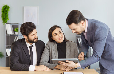 Couple clients join meeting with financial consultant, banker, or agent using tablet pc, discussing investment options, collaborative atmosphere in an office setting focused on money management.