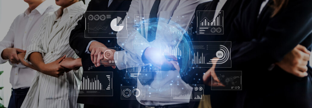 A business team stands confidently with arms crossed, featuring futuristic data visualizations that enhance the modern office atmosphere. Ideal for illustrating teamwork and innovation. Trope