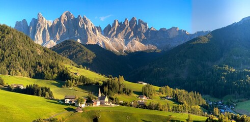 The church Chiesa di Santa Maddalena in Santa Magdalena in the UNESCO site mountains Dolomites in north Italy early in the autumn.